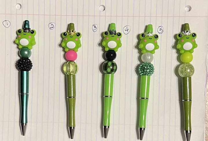 Five green frog pens in a row