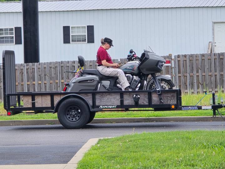 A rider on a touring motorcycle loaded on a trailer