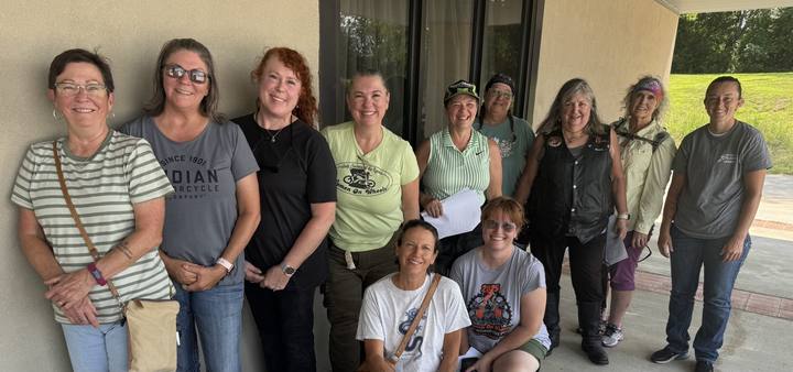 Ten members of the Lady Cruisers standing together under a covered entrance